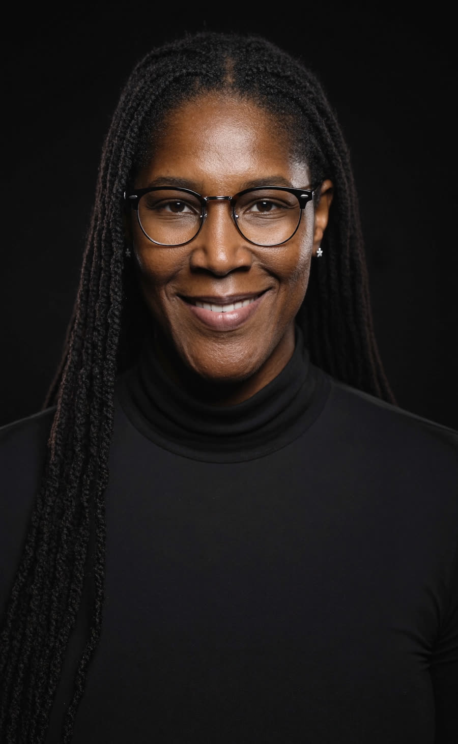 Michelle Snow, founder of Blue Cipher AI™, in a black studio portrait
